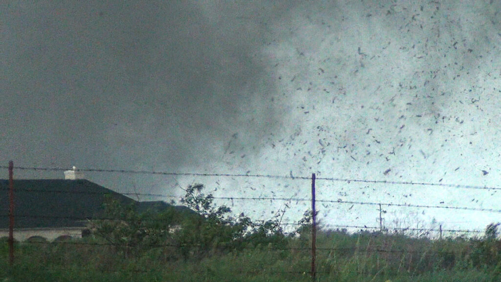 Debris in the air as the tornado approaches Sooner Rd. Video Still